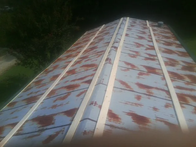 Rusted metal roof panels with new wood purlins before replacement — Storm Damage Roof Repair in New Kensington by Roofing Brothers