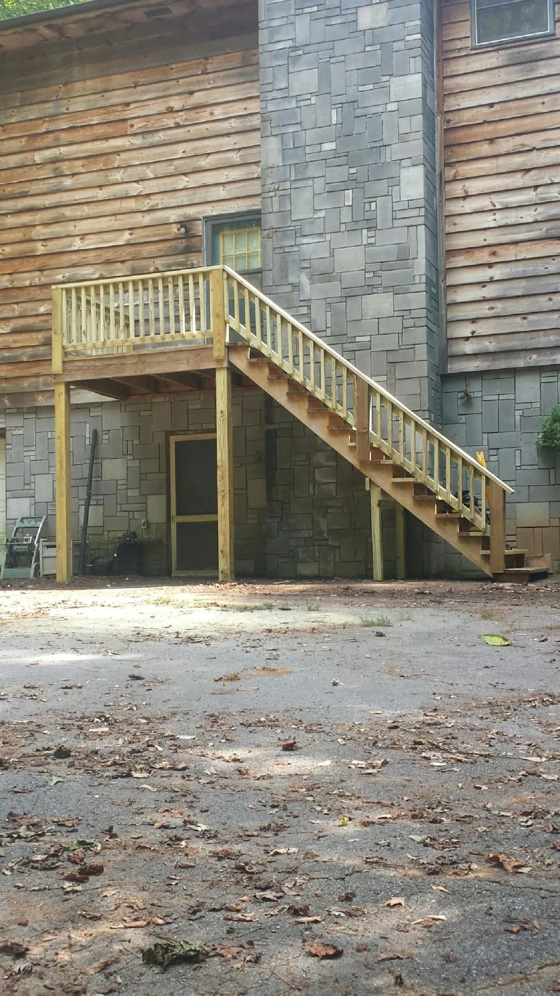 New pressure treated deck and stair landing on a log home in New Kensington